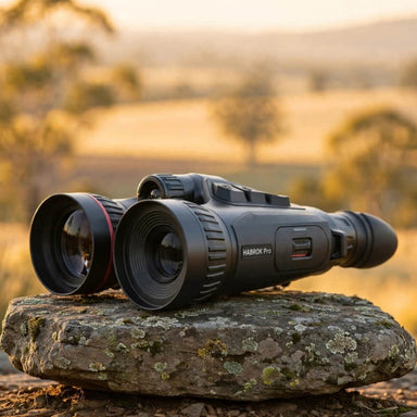 HIKMICRO Habrok Pro HX60L(N) Multi-Spectrum Binocular on top of a  Granite Bush Rock