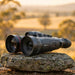 HIKMICRO Habrok Pro HX60L(N) Multi-Spectrum Binocular on top of a  Granite Bush Rock