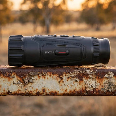 HIKMICRO Lynx LH35 3.0 Thermal Monocular on top of a Rusty Farm Gate Rail