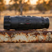 HIKMICRO Lynx LH35 3.0 Thermal Monocular on top of a Rusty Farm Gate Rail
