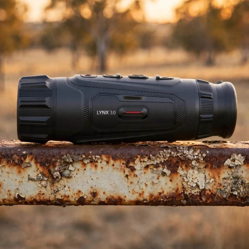 HIKMICRO Lynx LH35 3.0 Thermal Monocular on top of a Rusty Farm Gate Rail