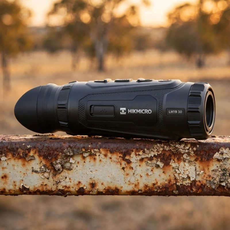 Hikmicro Lynx LH19 3.0 Thermal Monocular on top of a Rusty Farm Gate Rail
