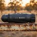 Hikmicro Lynx LQ35 3.0 Thermal Monocular on top of a Rusty Farm Gate Rail